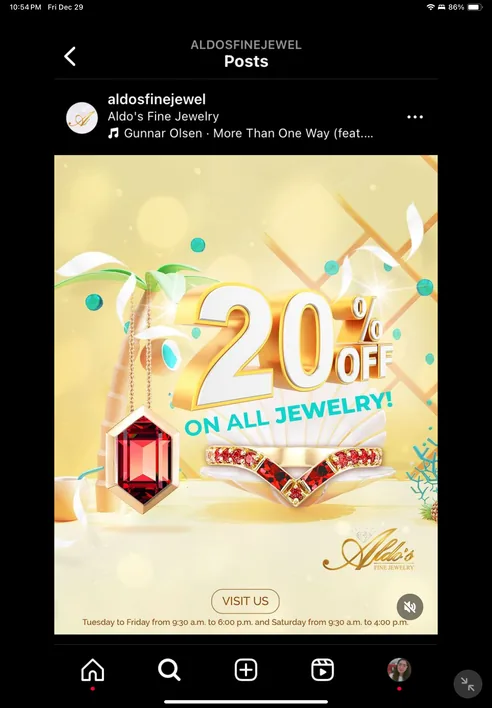 Instagram post on a tablet: 20% off on all jewelry, in gold lettering with a ruby pendant and a ring.