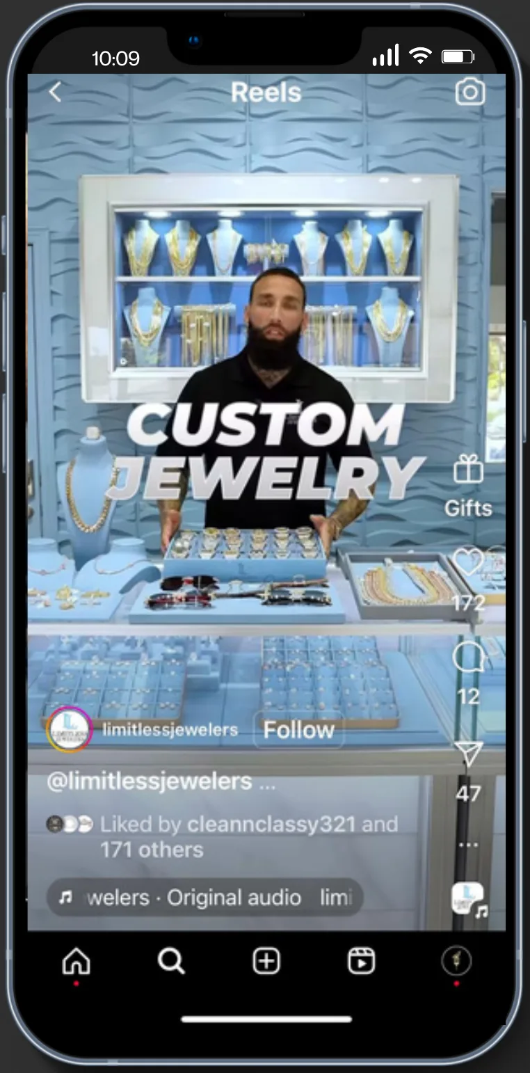 Phone showing an Instagram reel titled Custom Jewelry: a jeweler stands behind a display case of gold chains.